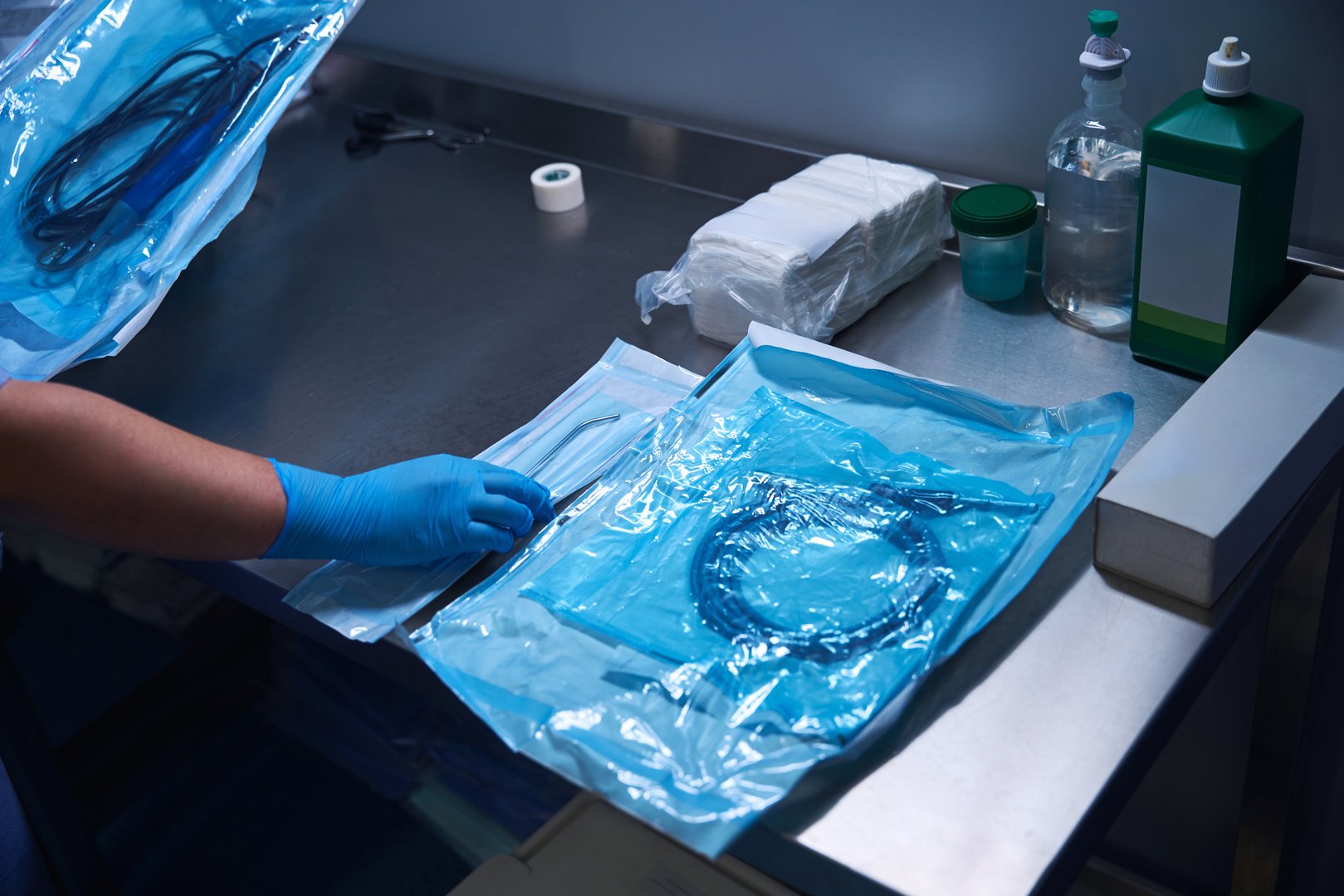 Close-up of sterile surgical tools laid out neatly on a blue drape, prepared for use in an upcoming procedure.