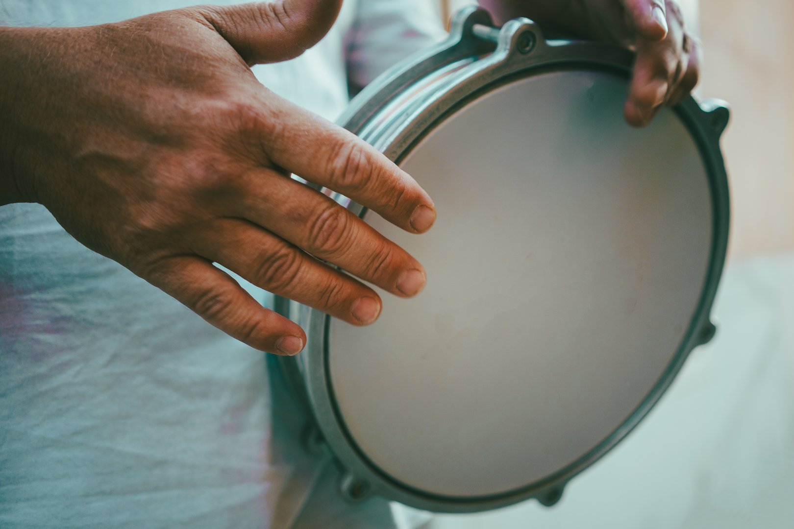 Metal tarabuka in hands, close up view.