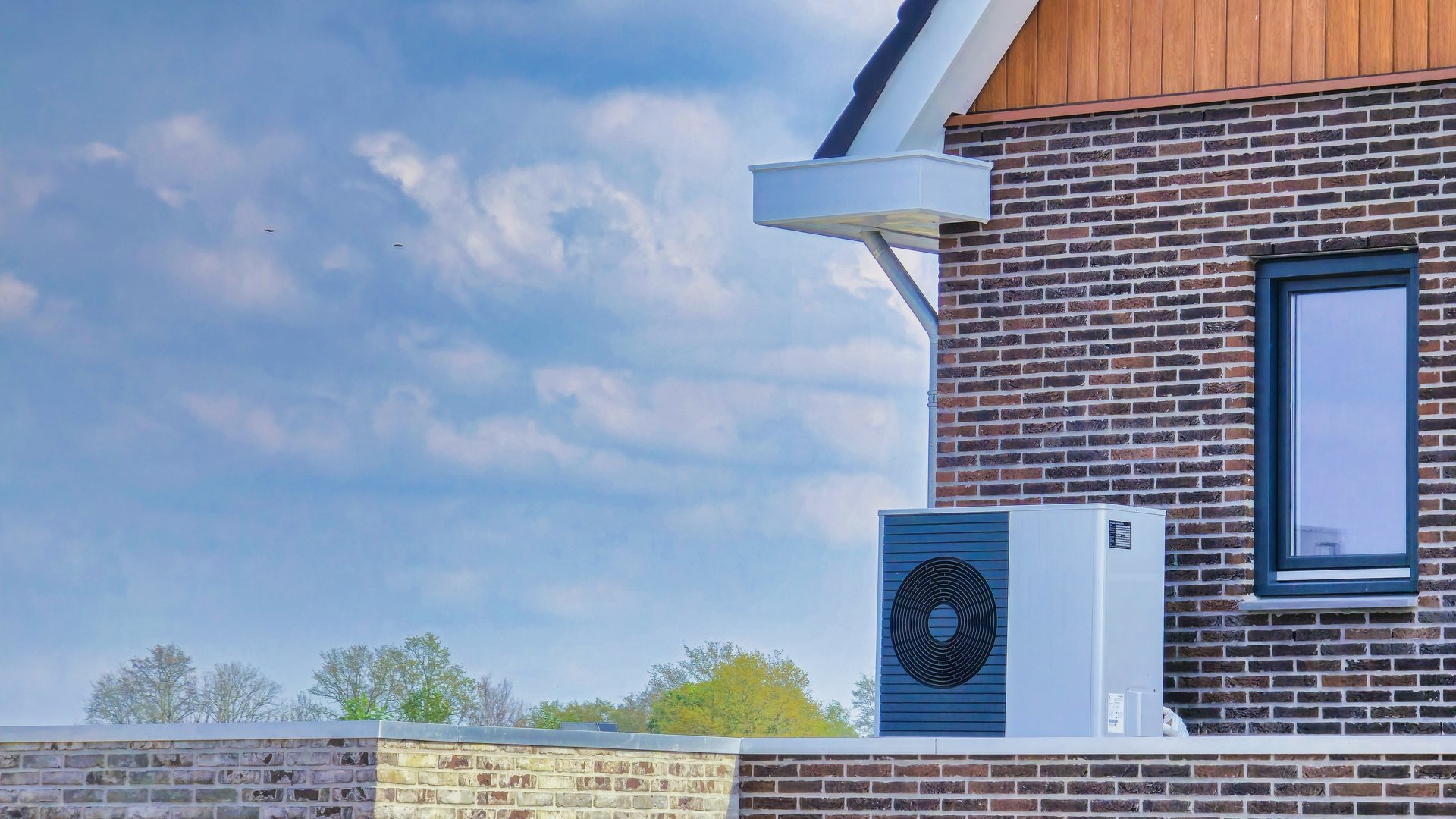 air source heat pump unit installed outdoors at a new home in the Netherlands, warmte pomp translation air source heat pump, energy transition from natural gas to an electric source