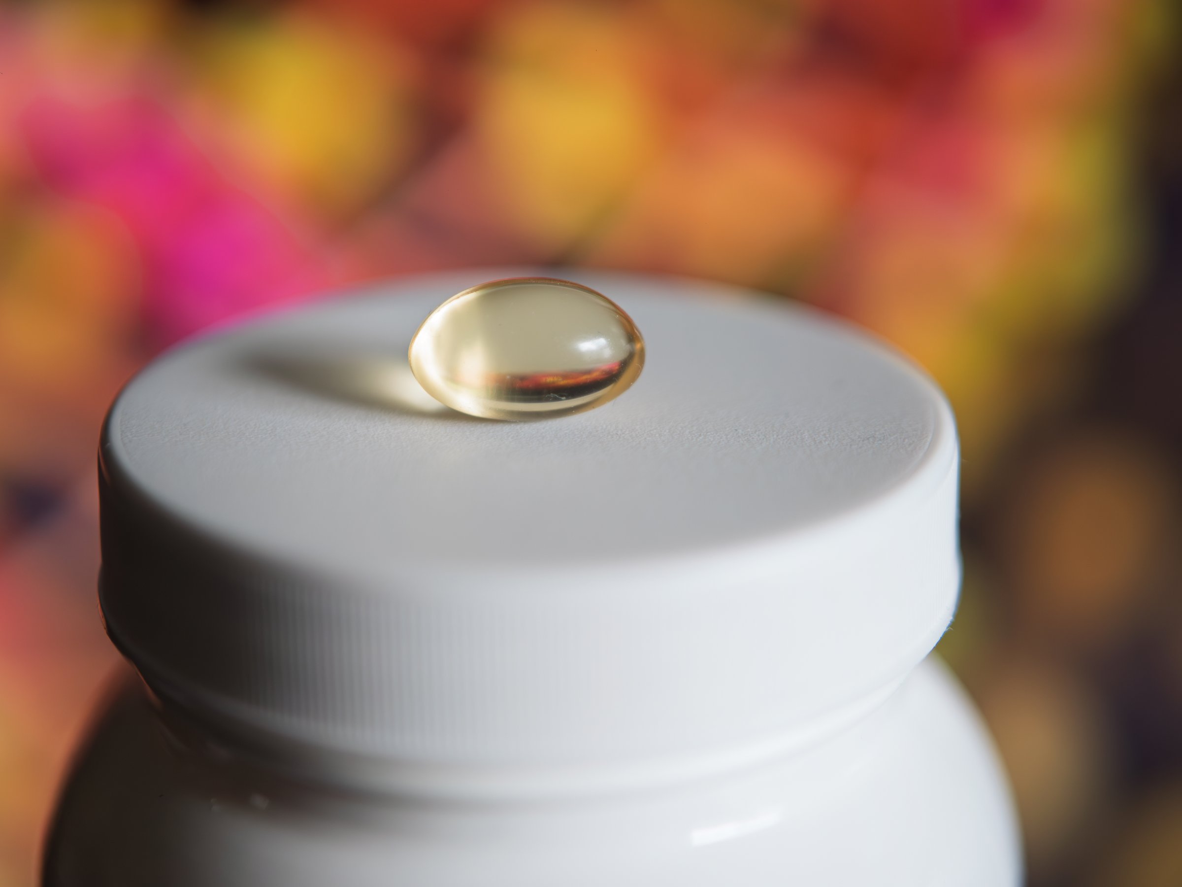 Nutritional Supplement Capsule on White Container
