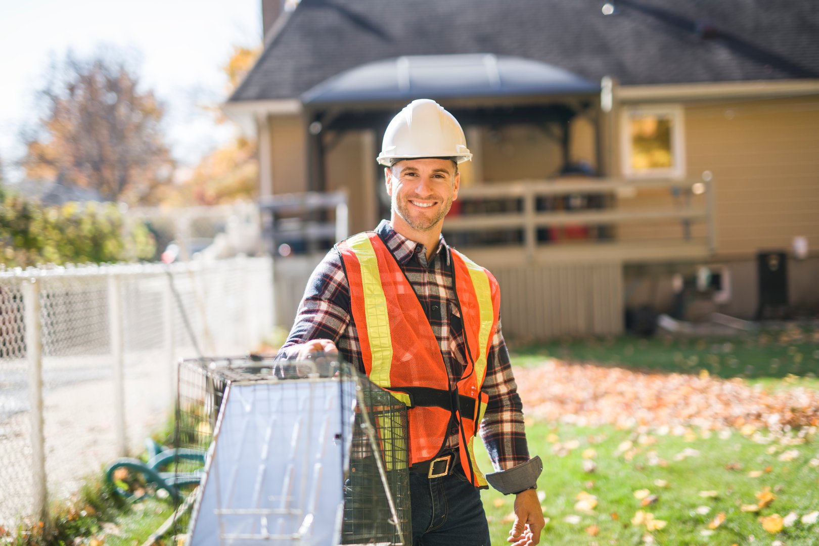 A man holding cage with trap for animal
