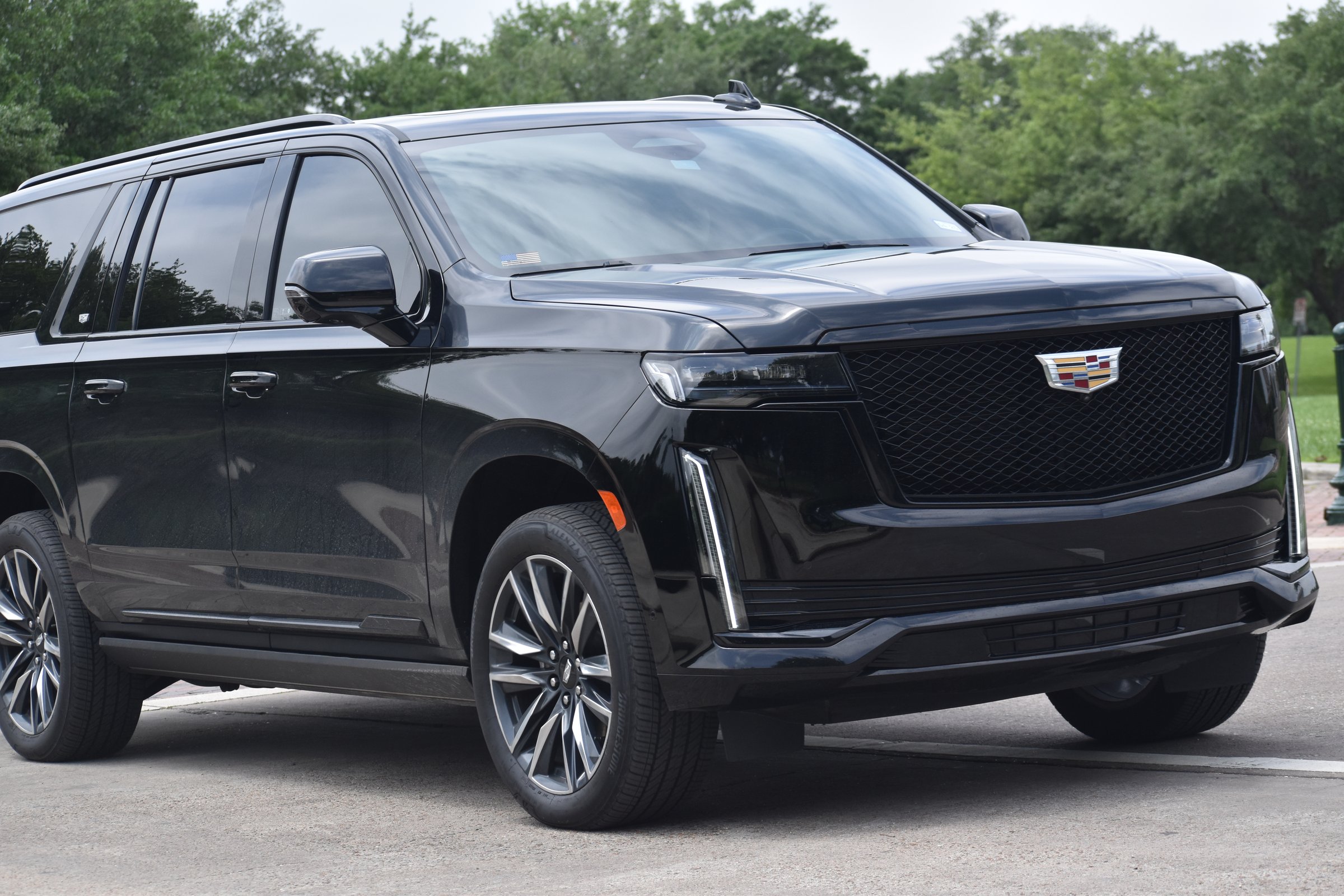 Houston, TX - 4-2024 A portrait of a black Cadillac Escalade (long wheelbase) cruising at a nature reserve