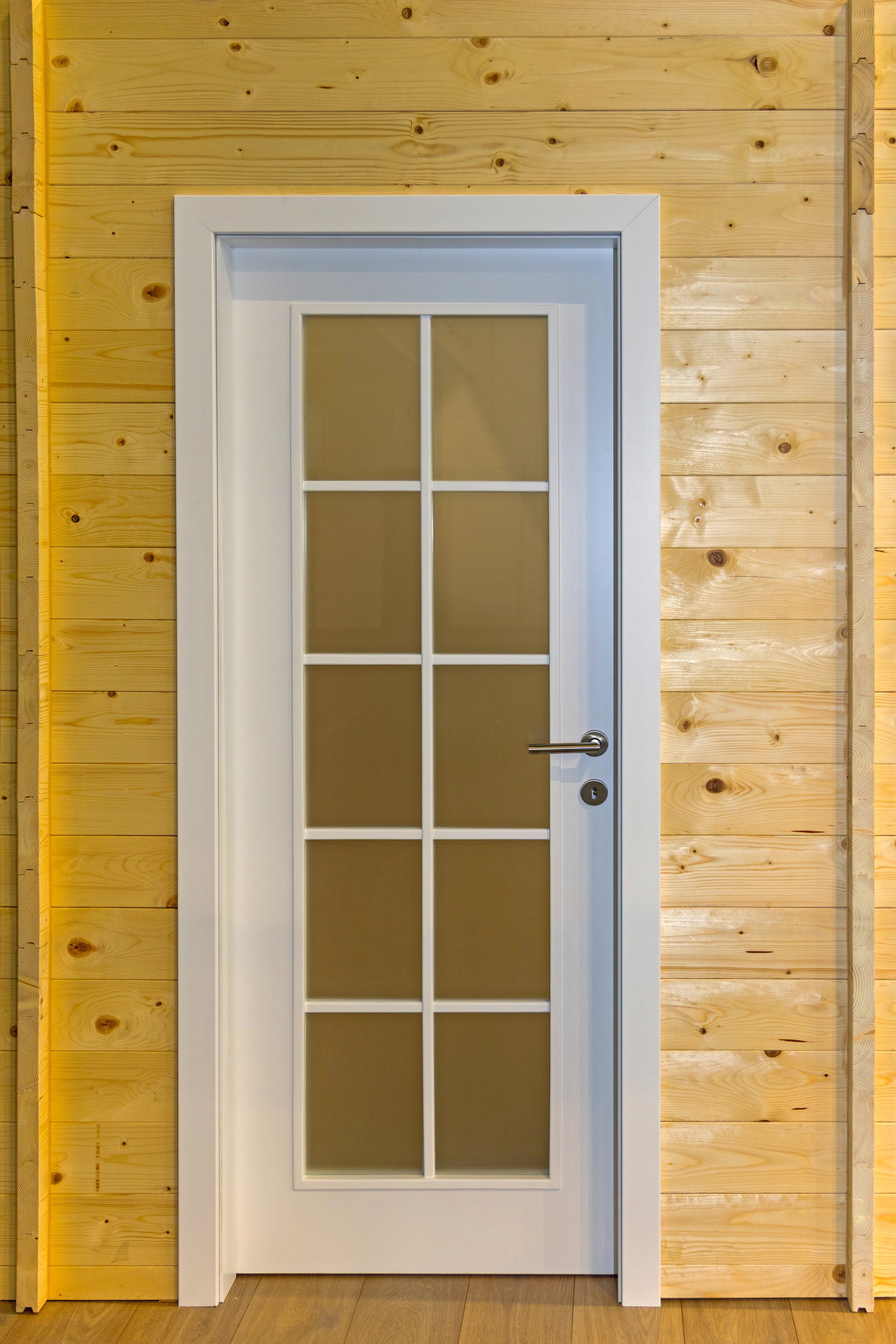 Closed White Glass Door at Light Wood Cabin House