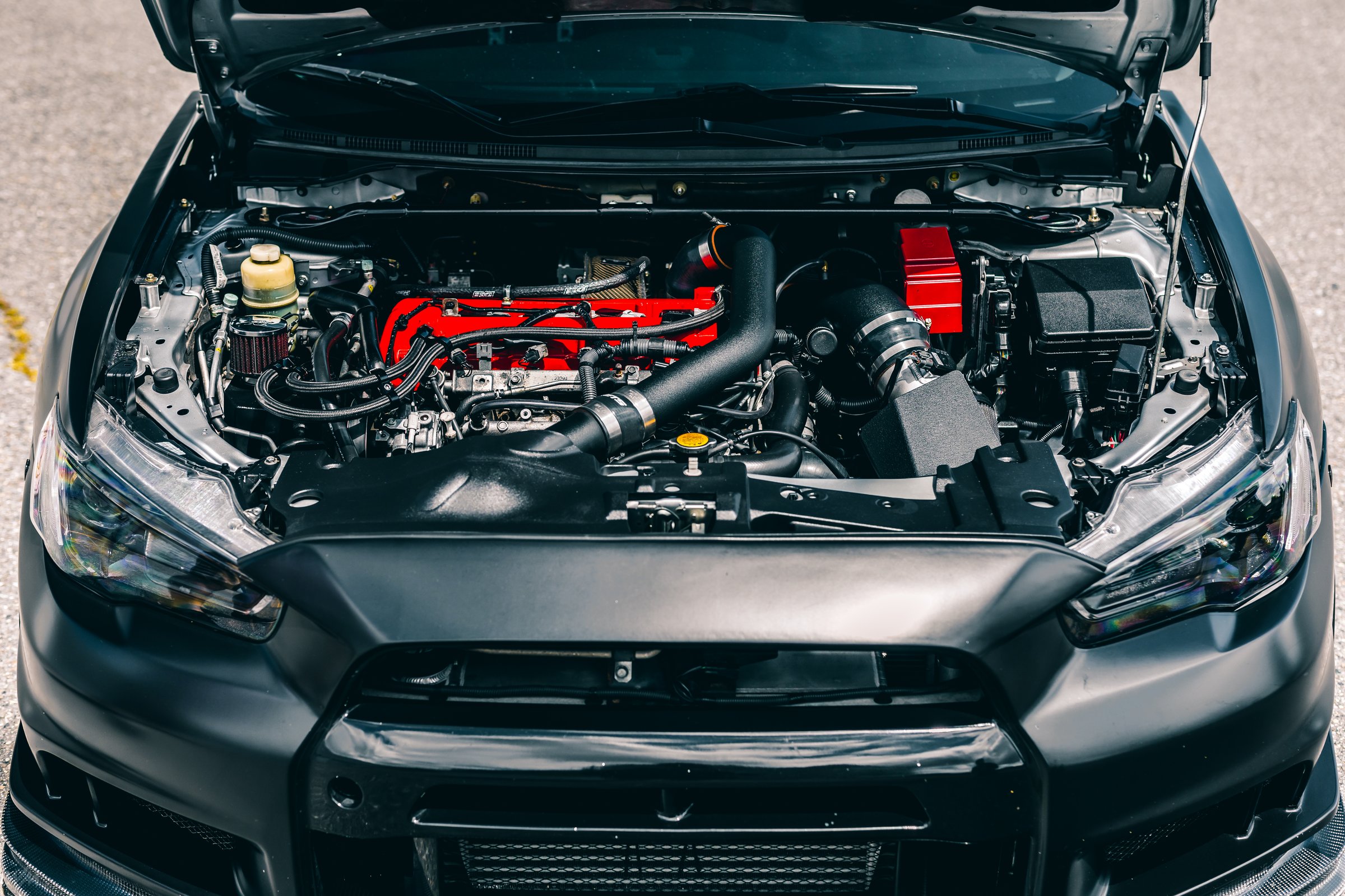 Seattle, WA, USA
7/19/2022
Black Mitsubishi EVO showing the engine bay
