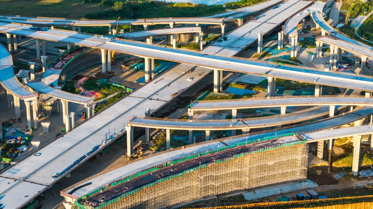 Aerial perspective showcasing a complex multi-layered highway interchange with interconnected elevated structures and ramps.