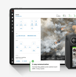 A digital tablet and drone controller showing a drone operation interface, including a live aerial view of a wildfire and on-screen controls. A highlighted text box reads "2-way communication: Connecting pilots and control room with 2-way audio."