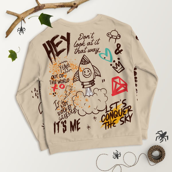 A tan sweater with writing on it