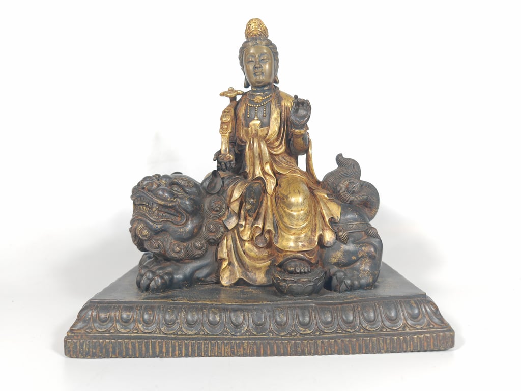 Bronze Sculpture depicting the Bodhisattva Guanyin seated on a Guardian Lion