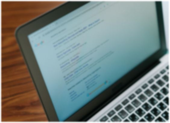 laptop screen on a wood table