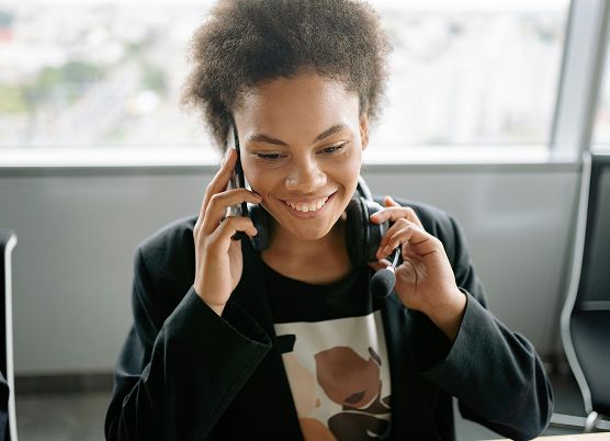 a smiling woman talking on the phone