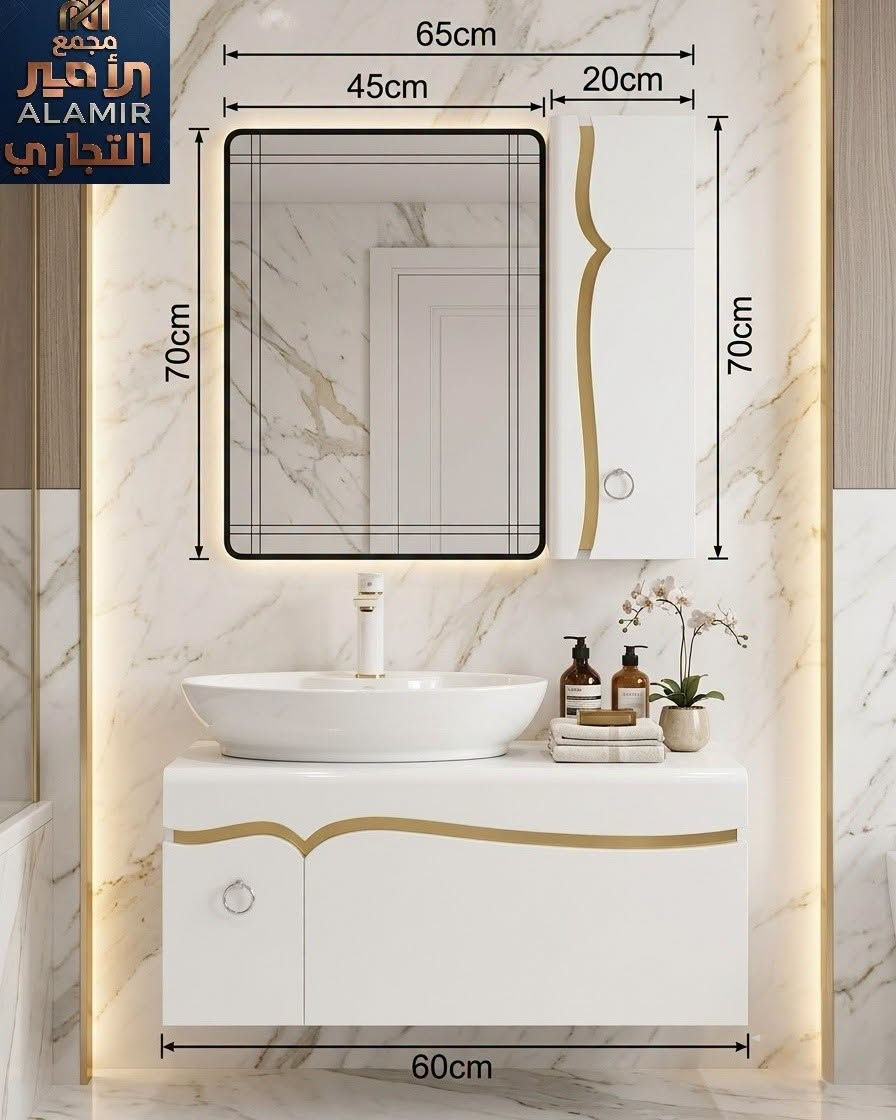تموجات الذهبي على نقاء الأبيض.. أنشئ حمام أحلامك! 🤍✨

​موديل استثنائي جديد يجمع بين بساطة اللون الأبيض وفخامة الخطوط الموجية الذهبية والمقابض الحلقية، متوفر الآن في #مجمع_الأمير_التجاري.

​🔹 مواصفات وتفاصيل الطقم:

​📐 قياسات مثالية: عرض الخزانة السفلية 60 سم (عرض المرآة مع الخزانة الجانبية 65 سم / ارتفاع 70 سم)، مناسبة جداً لمختلف المساحات. 

​👑 تفاصيل ذهبية انسيابية: شريط موجي ذهبي مطعم بدقة مع مقابض حلقية فاخرة.

​💡 مرآة LED ذكية: مرآة مستطيلة بإضاءة خفية دافئة تبرز جمال جدران الحمام.

​📦 تخزين ذكي: خزانة سفلية معلقة + خزانة علوية جانبية لاستغلال المساحة العمودية وترتيب كل مستلزماتك.

​🥼 حوض كاونتر بيضاوي: سيراميك أبيض عالي الجودة ناعم وسهل التنظيف.

​اجعل حمامك عنواناً للأناقة اليوم! ✨

​📍 العنوان: كربلاء المقدسة - منطقة الچاير - قرب مستشفى العباس الأهلي.

🚚 التوصيل: متاح وسريع لكافة المحافظات العراقية.

📞 للطلب والاستفسار
 *********** | ***********

​#مجمع_الأمير_التجاري #كربلاء #الچاير #مغاسل_مودرن #مغسلة_معلقة #صحيات_كربلاء #ديكورات #Karbala

نص مكتوب في الصور:
- مجمع الأمير التجاري 65cm 45cm 20cm 70cm 70cm 60cm
- مجمع الأمير التجاري ALAMIR
- مجمع الأمير التجاري ALAMIR 65cm 45cm 20cm 70cm 70cm 60cm