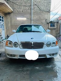 كيا اوبتيما 2005 لون ابيض  ويل كب بلادي  تبريد تدفئة شغال نقص بس غاز ل...
