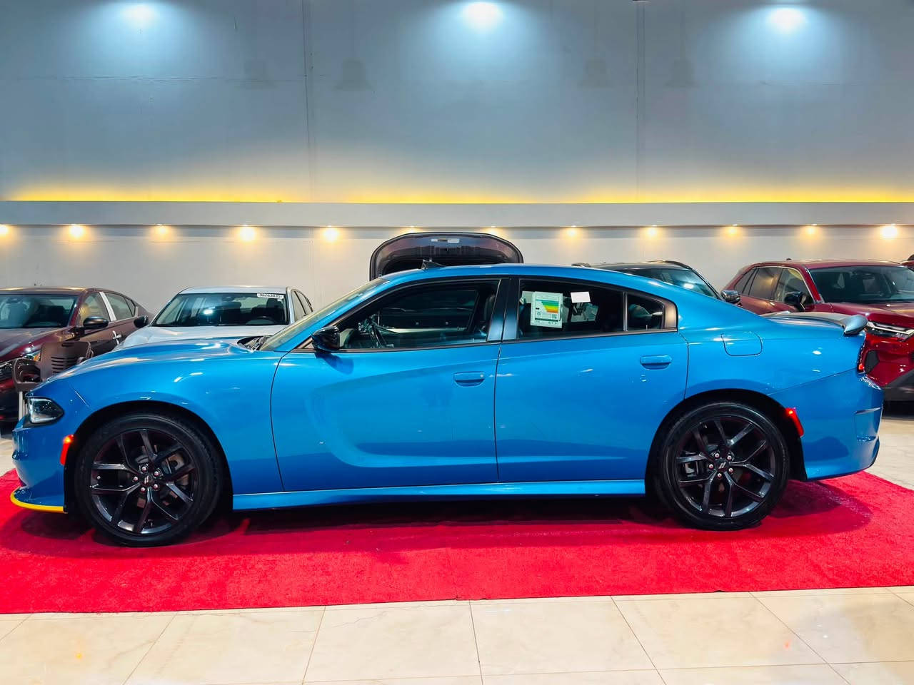 لطلب السعر علق بالرقم 1

2023 DODGE CHARGER GT PLUS 

3.6L V6 - GCC - LAST CALL ￼

مرقمة اربيل ✅

بطاقة بانزين✅

خليجي وكالة هارلم ✅❤️‍🔥

المحرك والاداء:
•  المحرك: 3.6 لتر V6 24V Pentastar - 6 سلندر ￼
•  القوة: 300 حصان ￼
•  العزم: 357 نيوتن / متر ￼
•  ناقل الحركة: 8 سرعات اوتوماتيك TorqueFlite 850RE مع Autostick و شفتات مقود ￼
•  الدفع: خلفي RWD - دفع خلفي
•  نظام التعليق: Performance Suspension مع مساعدات Bilstein رياضية و نسبة دفرنشل 3.07 ￼
•  التسارع: 0-100 تقريبا 6.4 ثانية
شنو يجي بفئة GT Plus - Plus Group:
هاي الفل الفل مال V6، مو GT العادي:
الخارجية:
•  جنوط 20 انج Black Noise اسود مطفي ￼
•  Blacktop Special Edition - كل الشبك والعلامات اسود Satin Black ￼
•  سبويلر خلفي اسود قطعة وحدة Performance Spoiler ￼
•  زنون + LED + بروجكتر ضباب Projector LED ￼
•  فتحة سقف Power Sunroof ￼
•  مرايا كهرباء مع تدفئة وذاكرة ونقطة عمياء BLIND SPOT/MEMORY/PWR/HEAT MIRRORS ￼
الداخلية والراحة:
•  مقاعد NAPPA/ALCANTARA Performance Seat جلد نابا مع الكانتارا رياضية ￼
•  مقاعد امامية تبريد وتدفئة Ventilated & Heated Front Seats ￼
•  مقاعد كهرباء مع ذاكرة وميموري للمرايا والراديو ￼
•  مقود Performance Steering Wheel تدفئة مع تحكم شفتات ￼
•  تدفئة مقود ومرايا ￼
•  شاشة 8.4 انج Uconnect مع Apple CarPlay و Android Auto ￼
•  نظام صوت Alpine بريميوم ￼
•  GPS Navigation مع Travel Group ￼
•  تشغيل عن بعد Remote Start و دخول بصمة Keyless ￼
•  ديكور كاربون فايبر حقيقي Real Carbon Fiber Interior Accents ￼
انظمة الامان والاداء:
•  Blind Spot and Cross Path Detection - نظام النقطة العمياء ￼
•  Dodge Performance Pages - صفحات الاداء والـ Launch Control ￼
•  كاميرا خلفية + حساسات
•  Traction Control و ABS و Cruise Control ￼
مواصفات خليجية GCC:
تجي مجهزة Middle East Equipment Group - راديتر اكبر، تبريد اضافي للمحرك Engine Oil Cooler، وكتابات عربية على المرايا 

العنوان📍

كركوك حي الخضراء شارع المعارض
معرض هشام الحمداني لتجارة السيارات

للاستفسار☎️📞

‭***********‬ 

*********** 

‭***********‬

￼
