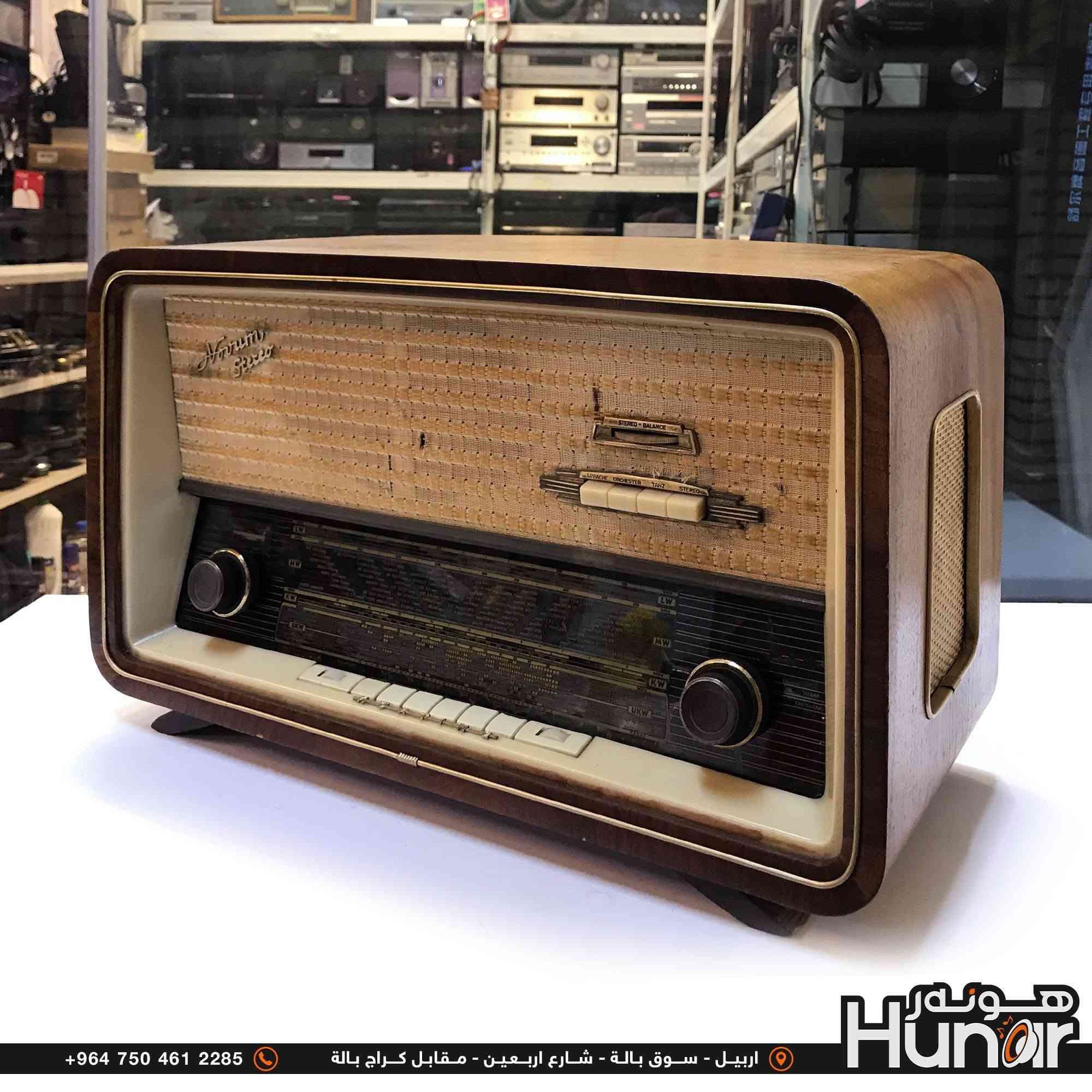 KORTING RADIO CLASSIC FM
هذا الجهاز هو راديو لامابي (أنبوبي / Vacuum Tube) ألماني كلاسيكي من طراز Novrum Stereo (صُنع بواسطة شركة Körting لشركة Delmonico).

​تفاصيل الجهاز:

​الموجات (عدد الموجات/الموجات المتاحة): يحتوي على 4 موجات رئيسية يُمكن التبديل بينها عبر مفاتيح التحكم والأزرار في واجهة الترددات: 
​عمر الراديو: 

​سنة الصنع: صُنع هذا الطراز في بداية ستينيات القرن الماضي (حوالي 1961 - 1964). 

​العمر: يتجاوز عمره 60 عاماً (نحو 62 إلى 65 سنة). 

​ملاحظات إضافية: 
( کوردی • عربي )

🟢توصيل موجود الي جميع المحافضات
🟡گەياندن هەیە بۆ هەموو شوێنێک

🟠مــعـرض هــونـەر
🔸للـصوتــیات(امبلیفایر• سماعة• رادیو• انتیك• مایكروفون)
🔸عــنـوان• اربیل سوق بالة • شارع اربعین
🔸مـوبایـل• ***********
                   ***********

🔵پـێـشانـگای هــونـەر
🔹بۆ ئامێری دەنگی و کارەبایی(ئیمپلیفایر• سەماعە• ڕادیۆ• مایکرۆفۆن)
🔹ناونیـشان• هەولیر • بازاری لەنگەی ٤۰م
🔹مـــۆبـایـل• 
***********
***********

•••••••••••••••••••••••••••••••••••••••••••••••••••
#iraq #kurdistan #duhok #zaxo #hawler #karbala #slemani #erbil #baghdad #kurd #kurdish #akre  #karkuk #kuwait #najaf
#amplifier #audio #subwoofer #sound #music #audiophile #bass #stereo #amplifiers #speaker #soundsystem #speakers
#اربيل #العراق #بغداد
​بلد المنشأ: ألمانيا الغربية (Western Germany).

​النظام: يعمل بتقنية الصمامات المفرغة (Vacuum Tubes) ويدعم الصوت الاستريو (Stereo).

​التصميم: الهيكل خارجي مصنوع من الخشب الطبيعي

​UKW / FM (موجات إف إم / الترددات العالية جداً)

​KW / SW (الموجة القصيرة - Short Wave)

​MW / AM (الموجة المتوسطة - Medium Wave)

​LW (الموجة الطويلة - Long Wave)

​عمر الراديو:

نص مكتوب في الصور:
- 32cm 54cm 22cm +964 750 461 2285 اربيل - سوق بالة - شارع اربعين - مقابل كراج بالة Hunar هونه ر
- +964 750 461 2285 اربيل - سوق بالة - شارع اربعين - مقابل كراج بالة Hunar
- +964 750 461 2285 اربيل - سوق بالة - شارع اربعين - مقابل كراج بالة
- +964 750 461 2285 اربيل - سوق بالة - شارع اربعين - مقابل كراج بالة Hunor
- +964 750 461 2285 اربيل - سوق بالة - شارع اربعين - مقابل كراج بالة هونر Hunar
- +964 750 461 2285 اربيل - سوق بالة - شارع اربعين - مقابل كراج بالة Húnor
- +964 750 461 2285 اربيل - سوق بالة - شارع اربعين - مقابل كراج بالة هنور Hunar