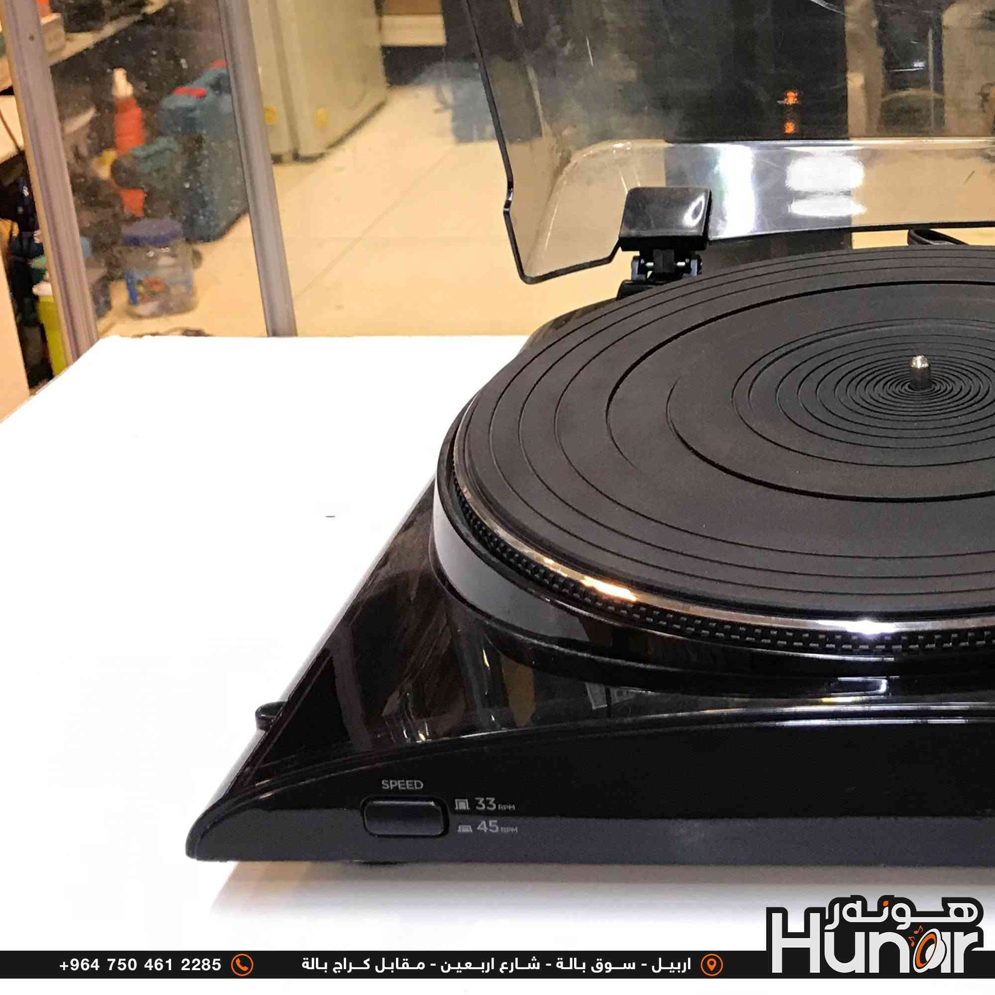 ION PROFILE PRO TURNTABLE
هذا الجهاز هو مشغل أسطوانات فاينيل (Turntable) رقمي ومحول صوتيات.

​الماركة والموديل:

​الماركة: ION Audio

​الموديل: Profile Pro (USB Turntable with Line Input)

​المواصفات والمميزات الأساسية:

​نظام التشغيل: يعمل بنظام الدفع بالسير (Belt-Drive).

​سرعات التشغيل: يدعم سرعتين أساسيتين (33 1/3 RPM للأسطوانات الكبيرة LP، و 45 RPM للأسطوانات الصغيرة) مع دعم تحويل أسطوانات 78 RPM عبر البرامج.

​منفذ USB: يتيح ربط الجهاز بالمبيوتر (PC / Mac) مباشرة لتحويل الأسطوانات القديمة إلى
ملفات صوتیة رقمية (MP3) بدون الحاجة لتعريفات.

​مضخم صوت داخلي (Built-in Preamp): مدمج به مضخم صوت داخلي، مما يتيح توصيله مباشرة بسماعات خارجية أو مضخم صوت (Amplifier/Home Stereo) عبر مخارج RCA دون الحاجة إلى مضخم خارجي.

​مدخل صوتي إضافي (3.5mm Aux Line Input): يتيح توصيل مصادر صوت أخرى (مثل​مدخل صوتي إضافي (3.5mm Aux Line Input): يتيح توصيل مصادر صوت أخرى (مثل مسجلات الكاسيت) لتحويل الصوت منها إلى MP3 عبر الكمبيوتر.

​غطاء حماية: مزود بغطاء بلاستيكي شفاف قابل للفتح والإغلاق لحماية الأسطوانات والإبرة من الغبار.

​المنافذ والأزرار: 

​أزرار اختيار السرعة (33 / 45 RPM) وزر التوقف (Stop).

​مخارج صوت استريو RCA للربط بالمسجل أو السماعات.

​منفذ USB للكمبيوتر.
( کوردی • عربي )

🟢توصيل موجود الي جميع المحافضات
🟡گەياندن هەیە بۆ هەموو شوێنێک

🟠مــعـرض هــونـەر
🔸للـصوتــیات(امبلیفایر• سماعة• رادیو• انتیك• مایكروفون)
🔸عــنـوان• اربیل سوق بالة • شارع اربعین
🔸مـوبایـل• ***********
                   ***********

🔵پـێـشانـگای هــونـەر
🔹بۆ ئامێری دەنگی و کارەبایی(ئیمپلیفایر• سەماعە• ڕادیۆ• مایکرۆفۆن)
🔹ناونیـشان• هەولیر • بازاری لەنگەی ٤۰م
🔹مـــۆبـایـل• 
***********
***********

•••••••••••••••••••••••••••••••••••••••••••••••••••
#iraq #kurdistan #duhok #zaxo #hawler #karbala #slemani #erbil #baghdad #kurd #kurdish #akre  #karkuk #kuwait #najaf
#amplifier #audio #subwoofer #sound #music #audiophile #bass #stereo #amplifiers #speaker #soundsystem #speakers
#اربيل #العراق #بغداد

نص مكتوب في الصور:
- +964 750 461 2285 اربيل - سوق بالة - شارع اربعين - مقابل كراج بالة هونر Hunor
- +964 750 461 2285 اربيل - سوق بالة - شارع اربعين - مقابل كراج بالة هونر Hunar
- +964 750 461 2285 اربيل - سوق بالة - شارع اربعين - مقابل كراج بالة Hunor
- +964 750 461 2285 اربيل - سوق بالة - شارع اربعين - مقابل كراج بالة
- +964 750 461 2285 اربيل - سوق بالة - شارع اربعين - مقابل كراج بالة Hunor هونه ر
- +964 750 461 2285 اربيل - سوق بالة - شارع اربعين - مقابل كراج بالة Hünar