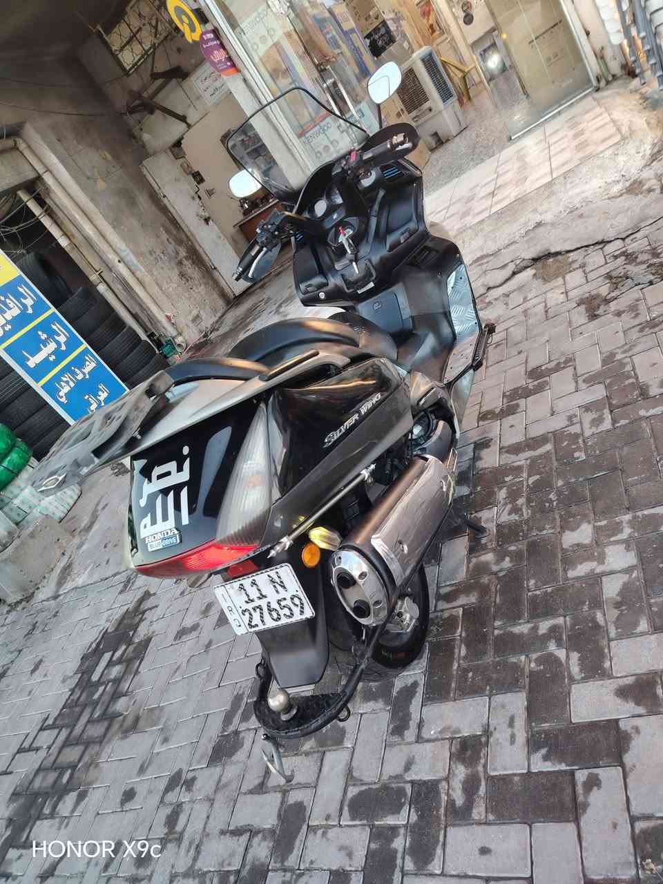 سلفر ونج مكينه 400 الدراجه مرقمه الدراجه كامله كل نقص مابيها المكينه  ممفترحه ابد الله ماشيه 73 الدراجه بيها شخرط بل الكفرات وبيها وفر مال سرعه شغال السعر 26 وبيها مجال المكان بغداد حي العامل الرقم ***********

نص مكتوب في الصور:
- HONOR X9c