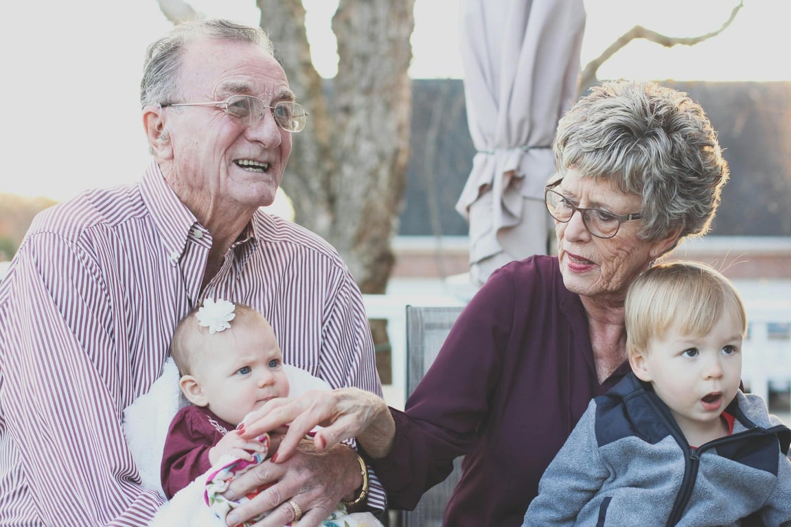 elderly couple with their grandchildren