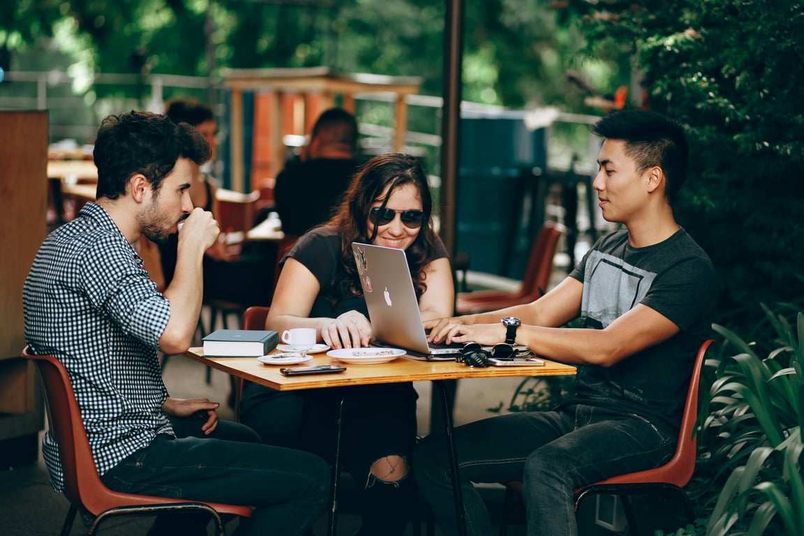 Young adults working at a coffee shop.