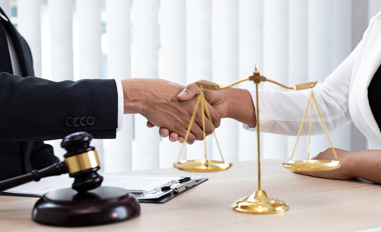 Lawyers or counselors join hands with clients to congratulate the end of the case by the company, Negotiation or settlement of lawsuits concept.