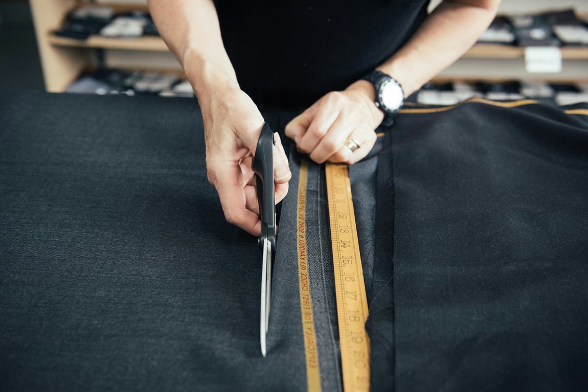 person cutting fabric