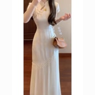 Woman wearing cream cheongsam dress showcasing fit and traditional design elements