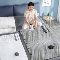 Woman using electric pump to compress vacuum storage bags for travel