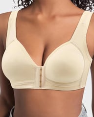 Woman wearing beige front closure wireless support bra, close-up of front fastening