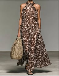 Full-length view of women's brown speckled maxi dress with ruffled halter detail
