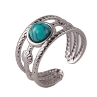 Close-up silver wide-band turquoise ring with adjustable openwork design