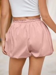 Back view woman pink high-waisted bubble shorts demonstrating distinctive puffy silhouette
