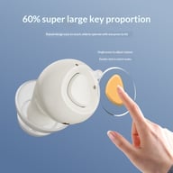 Close-up of hearing aid showing large button for volume control