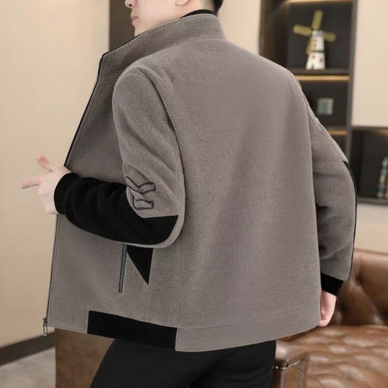 Rear view of man in grey and black stand-neck jacket showing design details