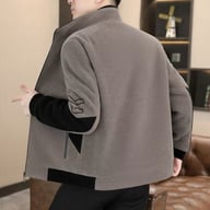 Rear view of man in grey and black stand-neck jacket showing full back design