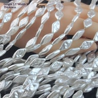 Baroque pearl beads with dimensions displayed on hand showing size and shape
