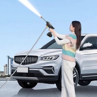 Woman using cordless car washer on white SUV outdoors