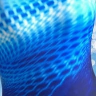 Back view showing racerback design and circular cutout on form-fitting one-piece