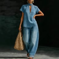 Woman wearing light blue faux denim two-piece set with tote bag