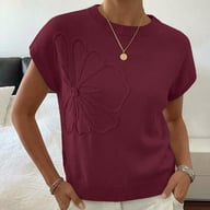 Woman wearing burgundy jacquard flower sweater with gold necklace, casual styling