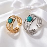 Gold and silver wide-band turquoise adjustable rings on satin background