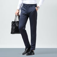 Man wearing navy blue slim fit ice silk dress pants with black leather bag