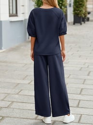 Back view of woman in navy wide leg tracksuit set showing fit