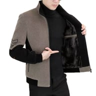 Man displaying thick black fleece lining inside grey and black stand-neck jacket