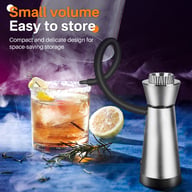 Portable smoke infuser smoking a craft cocktail with lemon garnish