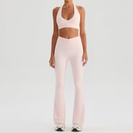 Pink halter bra with high-waisted flared tennis skirt fitness outfit