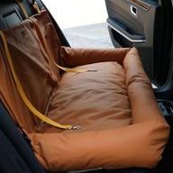 Brown waterproof car dog bed installed in luxury car backseat with dog resting