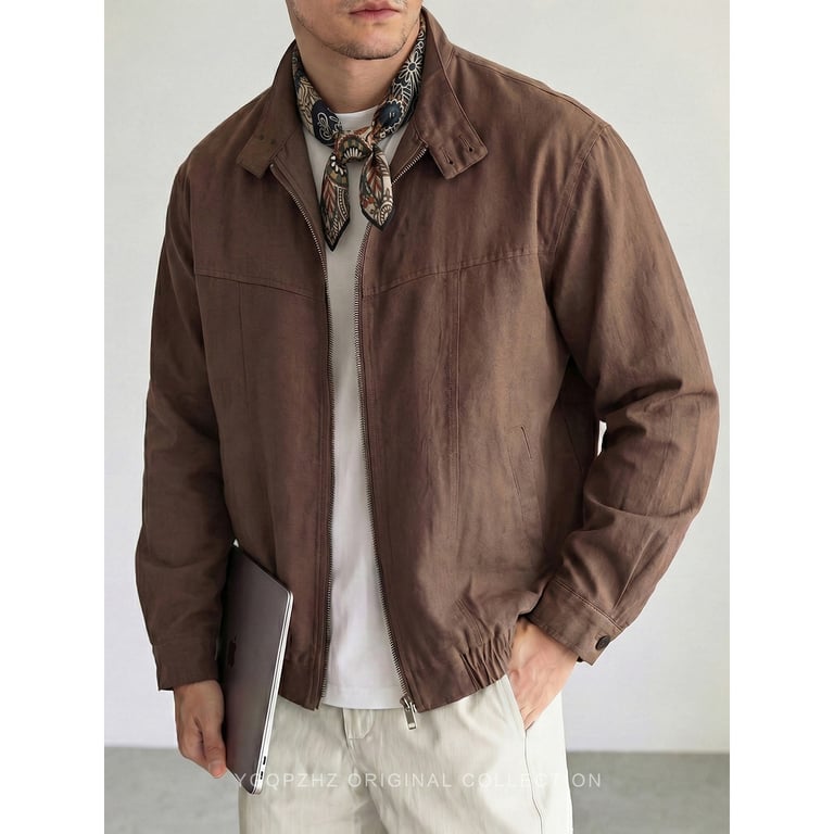 Man in brown vintage stand-collar utility jacket holding coffee cup, accessible luxury