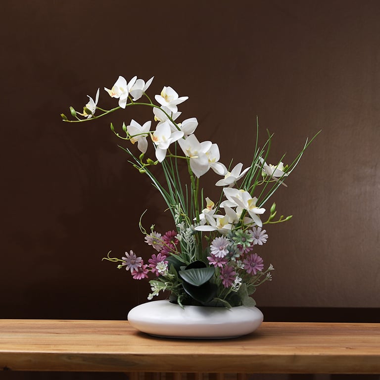 Silicone orchid arrangement displayed on professional office desk workspace