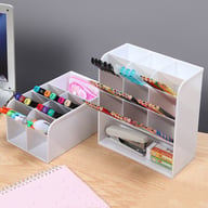 White desk organizer filled with pens, pencils, and office supplies neatly sorted