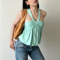 Woman wearing mint green ruched halter camisole top with jeans