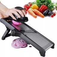 Mandoline slicer in use with red onion and various vegetables